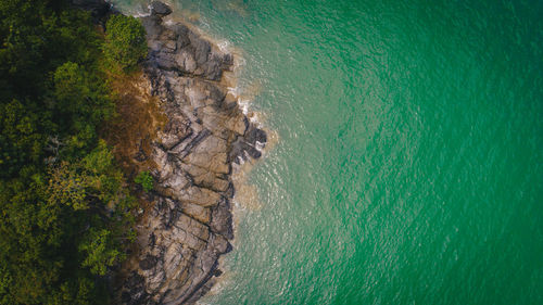 Aerial view of rocks on sea shore at beach