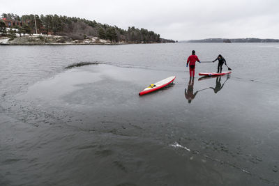 Man and woman paddle boarding