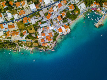 Aerial view of houses in town by sea