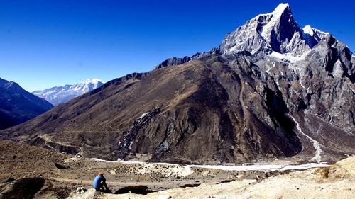 Scenic view of snowcapped mountains against clear blue sky