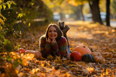 Portrait of young woman sitting on field