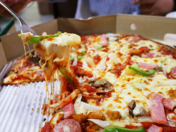 Close-up of pizza served on table in restaurant