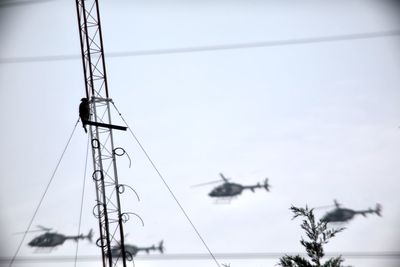 Low angle view of electricity pylon against sky