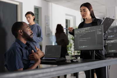 Side view of business colleagues working at office