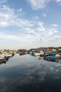 High angle view of sailboats moored at harbor against sky