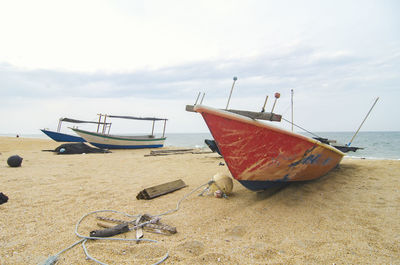 Boats moored on beach