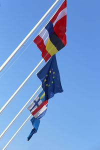 Many international flags and the european flag and sky on background