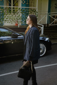 Rear view of woman standing on street