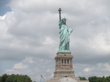 Low angle view of statue against cloudy sky