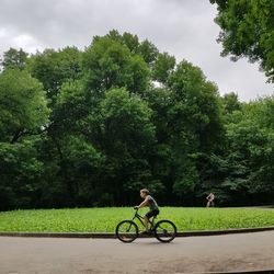 Side view of woman riding bicycle on road