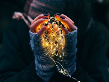 Close-up of woman holding lights