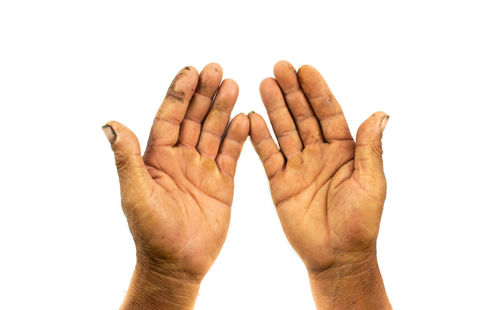 Close-up of wrinkled human hands against white background