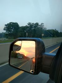 Reflection of car on side-view mirror