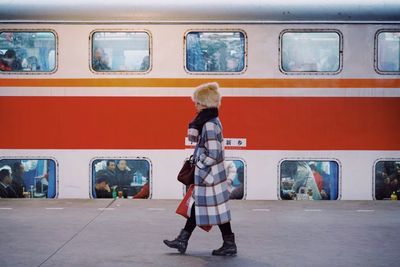 Full length of woman standing train at railroad station