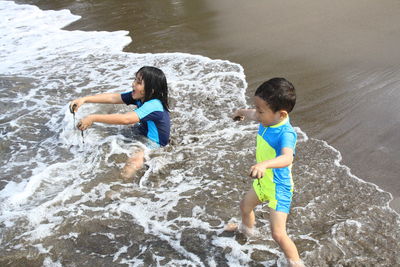 Children are playing  at the beach