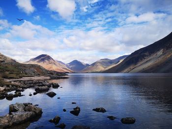 Scenic view of lake and mountains against sky