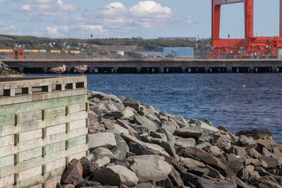 Scenic view of sea by buildings against sky