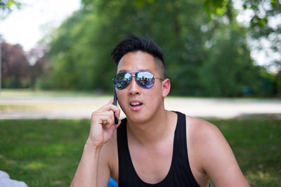 Handsome man talking on phone in park