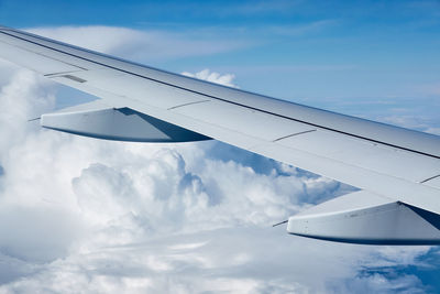 Cropped image of airplane wing against sky