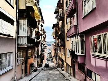 Street amidst buildings in city against sky