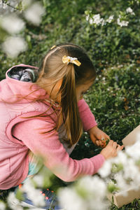 Side view of girl playing with dog