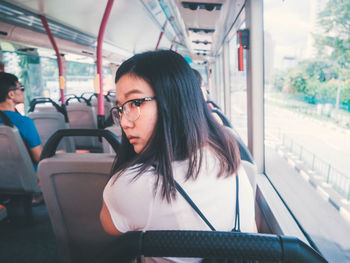 Portrait of young woman in train