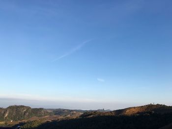 Scenic view of landscape against blue sky