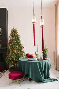 Table served for christmas dinner in living room, close-up view, table setting