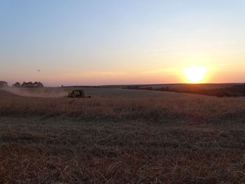 Scenic view of field against sky during sunset