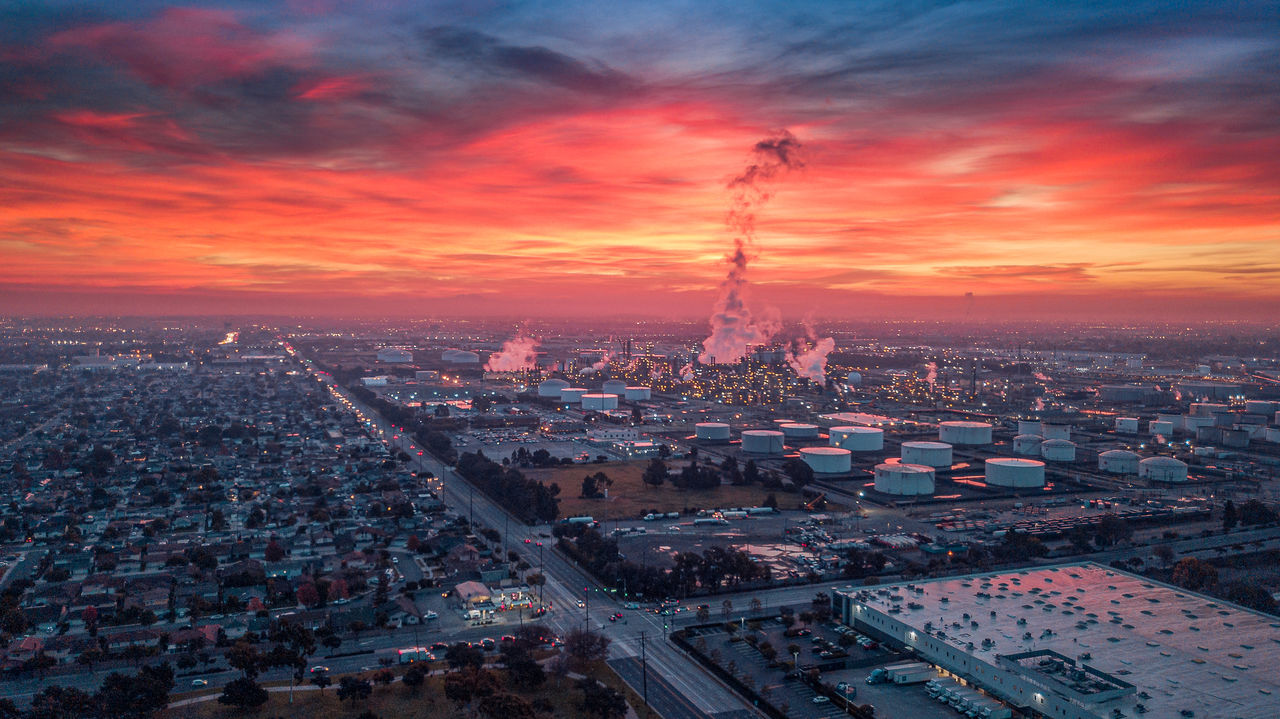 city, architecture, building exterior, cityscape, built structure, crowd, sky, sunset, crowded, cloud - sky, high angle view, aerial view, nature, city life, travel destinations, building, smoke - physical structure, transportation, outdoors, pollution