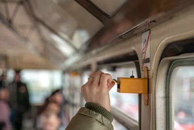 Midsection of person holding train