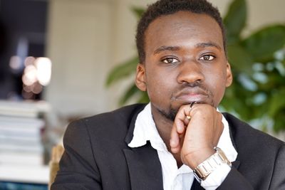 Portrait of young man smoking cigarette