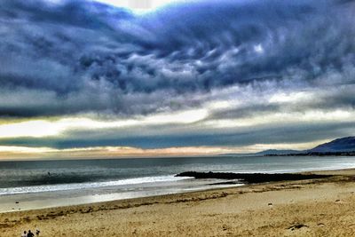 Scenic view of sea against cloudy sky
