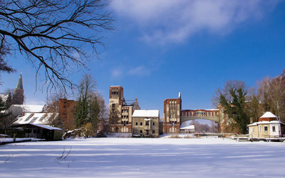 Houses in town against clear sky during winter