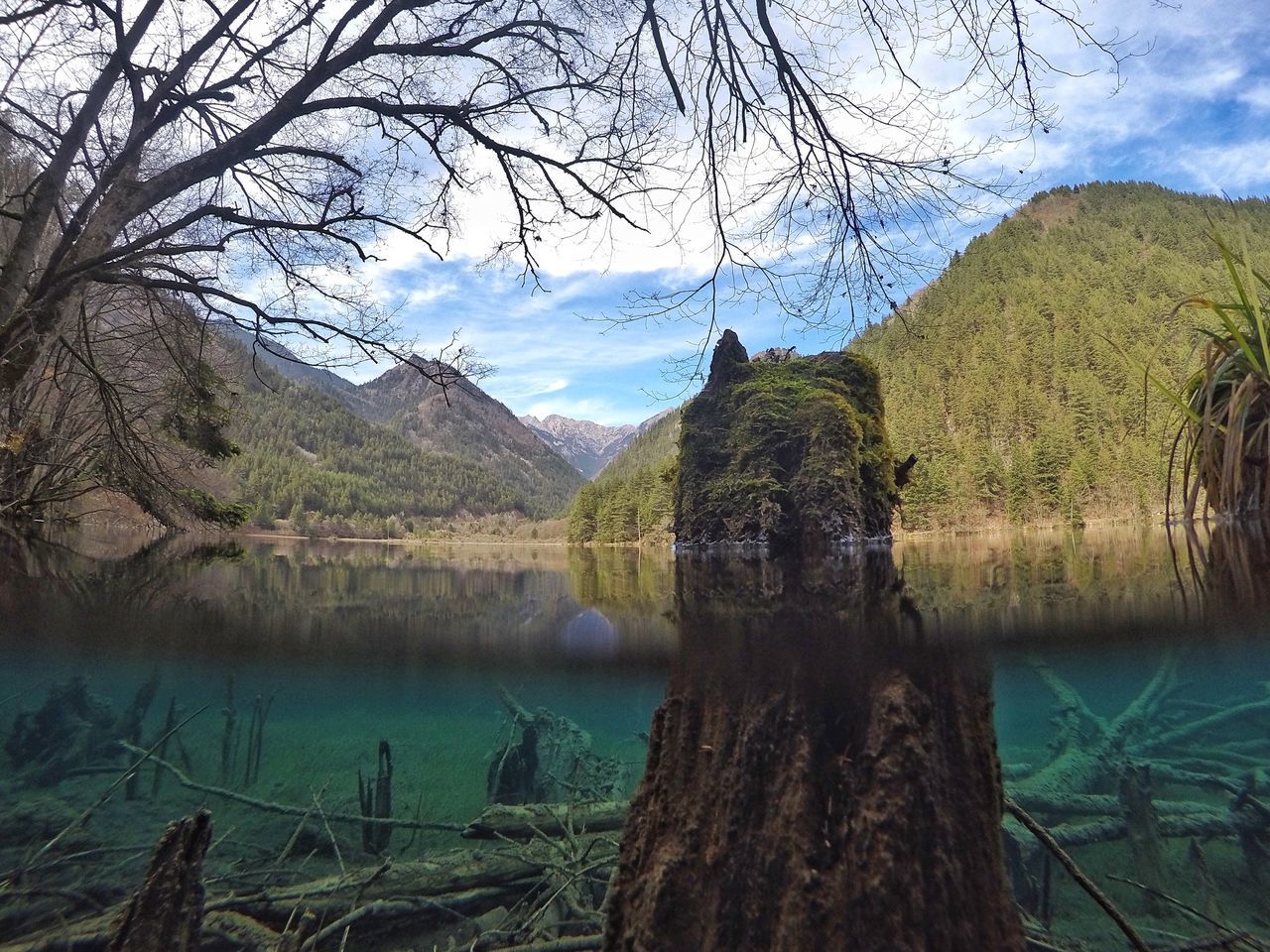 tranquil scene, tranquility, scenics, water, mountain, sky, lake, beauty in nature, nature, tree, landscape, mountain range, idyllic, reflection, bare tree, non-urban scene, countryside, branch, cloud, cloud - sky