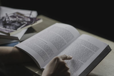 Cropped hand of woman reading book