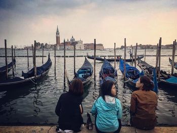 Rear view of people on boat in canal