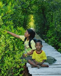 Happy friends against trees and plants