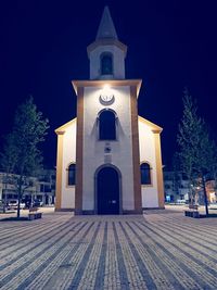 Facade of building against sky at night