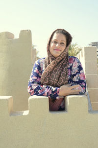 Portrait of a smiling young woman sitting outdoors