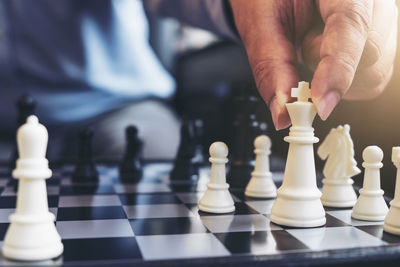 Midsection man playing chess at home 