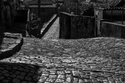 Cobblestone street amidst buildings in city