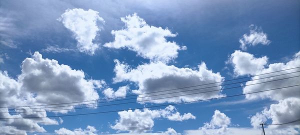 Low angle view of cables against blue sky