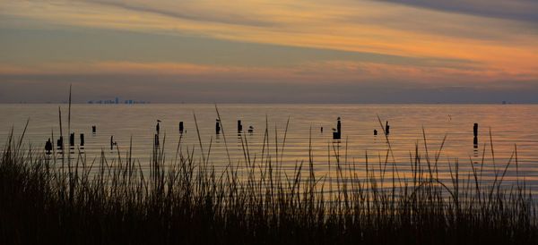 Scenic view of sea against sky at sunset