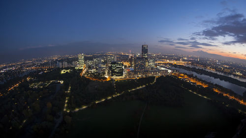 Aerial view of city lit up at night