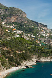 Scenic view of sea and buildings against sky