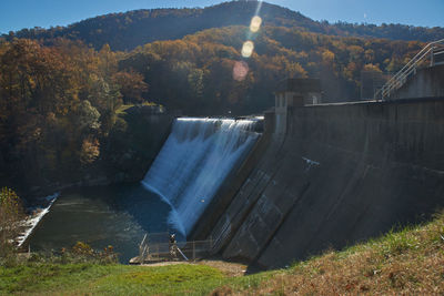 High angle view of dam by trees