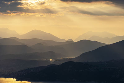 Scenic view of silhouette mountains against sky during sunset