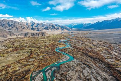 Aerial view of landscape against cloudy sky