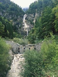 Scenic view of waterfall on mountain against sky